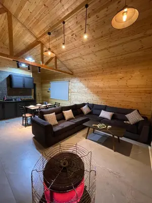a living room with a couch and a table at Cherry farm in Ajloun