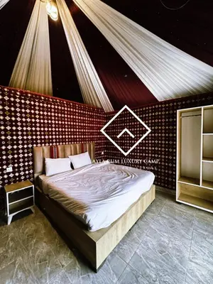 a bedroom with a large bed in a room at ALYA RUM LUXURY Camp in Wadi Rum