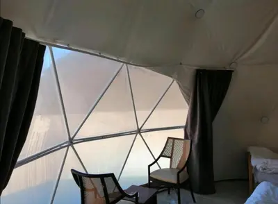 two chairs in a room with a large window at mountains wadi rum in Disah
