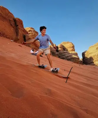 a man standing in the sand in the desert at mountains wadi rum in Disah