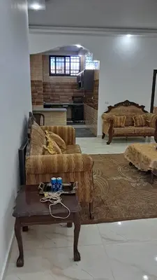 a living room with a couch and a table at فيلا سالم عبدالرحمن الأشــــــقــــر ابو حمزه Villa Salem Alashqar in Maḩaţţat al Jīzah