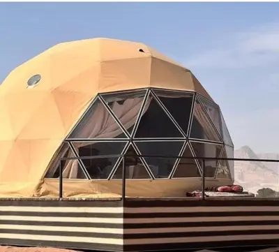 a dome tent sitting on top of a field at Rum Magic Bubbles in Wadi Rum