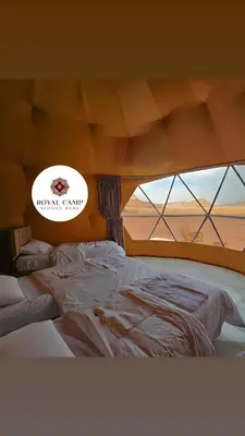 a large bed in a room with a window at Thirteen Luxury Camp Valley in Wadi Rum