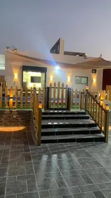 a church with stairs and a wooden fence at مزرعة الخربه in Khirbat Abū al Khass