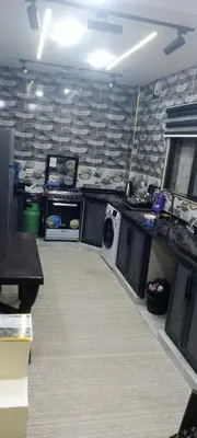 a large room with a kitchen with a microwave at مزرعة الخربه in Khirbat Abū al Khass