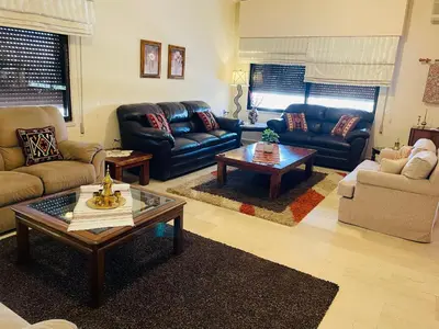 a living room with couches and a coffee table at شقة مفروشة الدوار الخامس in Amman