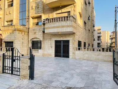 a building with a gate in front of it at شقة مفروشة بالجبيهة in Amman