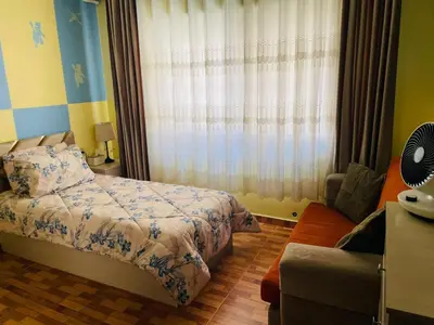 a bedroom with a bed and a window at شقة مفروشة بالجبيهة in Amman