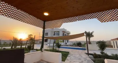 a house with a hammock in front of a house at شاليه ريست سي Rest Sea Chalet