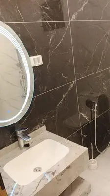 a bathroom with a sink and a mirror at شاليه ريست سي Rest Sea Chalet