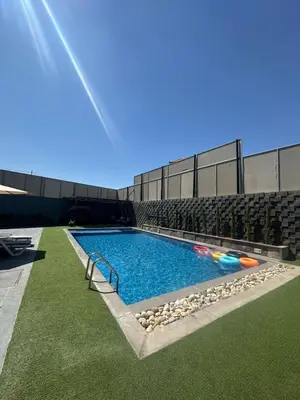 a swimming pool with balls in the water at Villa Ohaio in Amman