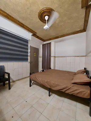 a bedroom with a large bed with a ceiling at Stone house in Amman