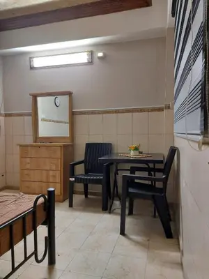a room with a table and two chairs and a screen at Stone house in Amman
