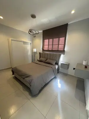 a bedroom with a large bed and a window at Roof 99 in Amman