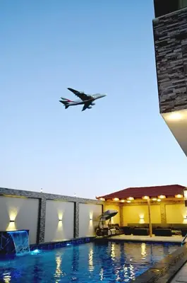 a bird flying over a swimming pool at For daily, weekly monthly and yearly stays in Amman