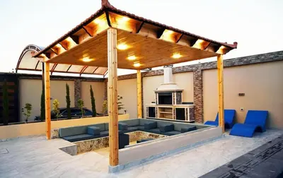a pergola on top of a house with blue chairs at Sky Villa in Amman