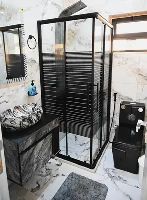 a bathroom with a black and white marble shower at Sky Villa in Amman