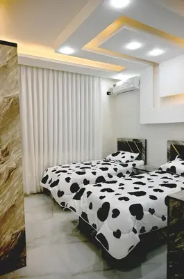 two beds in a room with black and white at Sky Villa in Amman