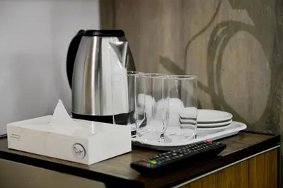 a blender and a remote control on a table at Rose In Apartment in Wadi Musa
