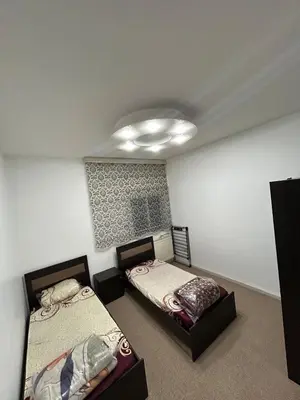 a bedroom with two beds and a ceiling at Toum's Apartments 2 in Amman