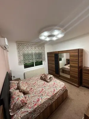 a bedroom with a large bed and a large mirror at Toum's Apartments 2 in Amman