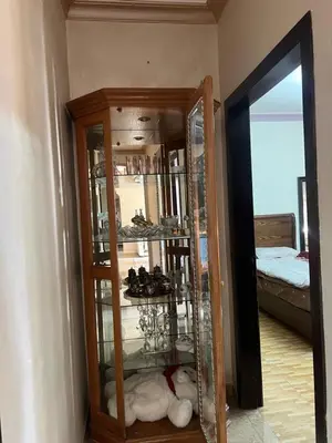 a room with a glass cabinet with shoes in it at كرم الضيافة in Amman