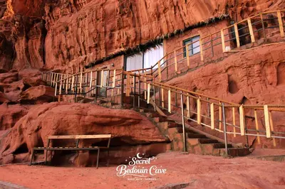 a building in a cliff with a staircase in it at Bedouin Secret Cave in Wadi Rum