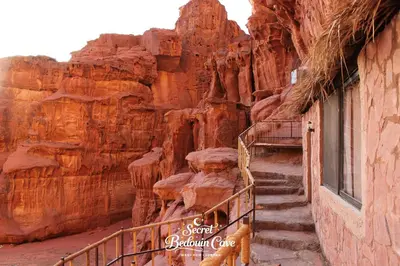 a set of stairs in a canyon with a building at Bedouin Secret Cave in Wadi Rum