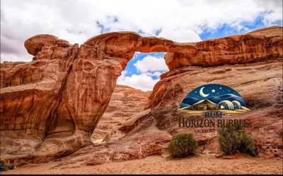 a view of the arch at the entrance to the rock formation at RUM HORIZON BUBBlE LUXURY CAMP in Wadi Rum