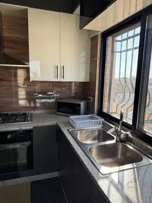 a kitchen with a sink and a window at 2bd apartment sport city in Amman