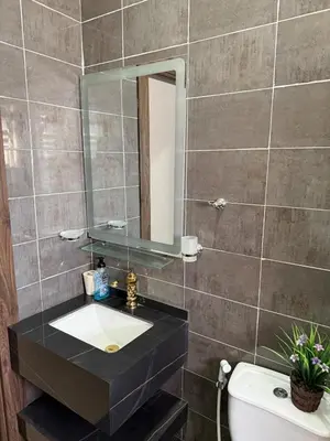 a bathroom with a sink and a mirror at 2bd apartment sport city in Amman