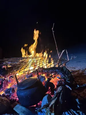 a pot sitting on top of a fire at Sleeping amidst the natural beauty of Wadi Rum, and living like a Bedouin in Aqaba