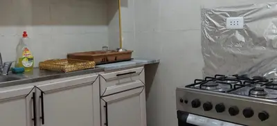 a kitchen with a stove and a counter top at Stone house in Amman