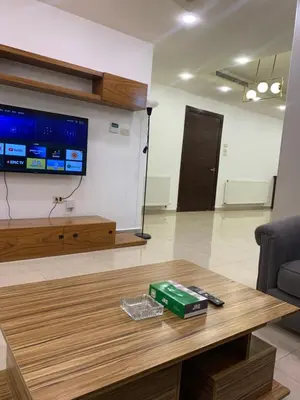 a living room with a coffee table and a flat screen tv at dabouq 3bedroom near all services JRE in Amman