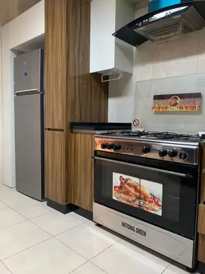 a kitchen with a stove and a refrigerator at dabouq 3bedroom near all services JRE in Amman