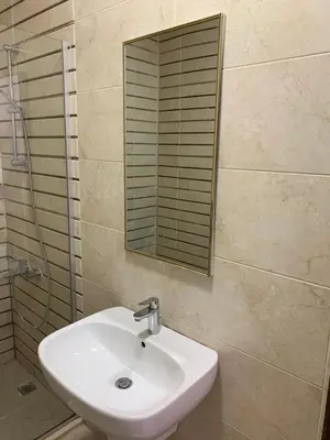 a bathroom with a sink and a mirror at dabouq 3bedroom near all services JRE in Amman