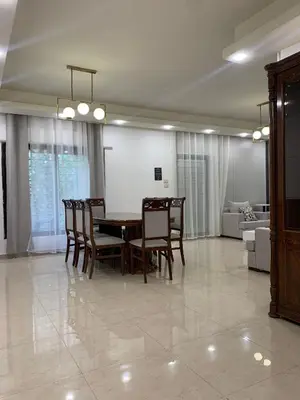 a dining room with a table and chairs at Luxurious 3 Bedroom Apartment in Heart of Amman in Amman