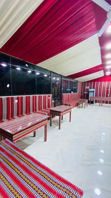 a row of benches in a building with red walls at Rum Horizon Camp& Tours in Wadi Rum