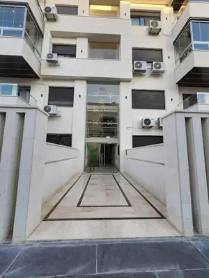 a building with a hallway in front of it at Cozy Appartment In Shmessani in Amman