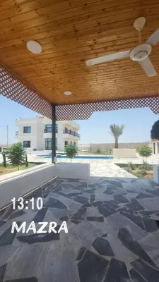 a patio with a wooden ceiling and a stone floor at Rest Sea Chaliet & Farm