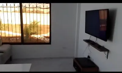 a living room with a flat screen tv and a window at Rest Sea Chalet Private Room