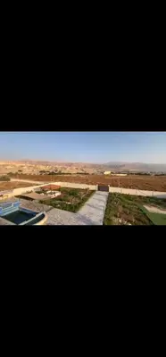 a view of a desert with a building and a pool at Rest Sea Chalet Private Room