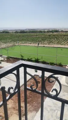 a view of a tennis court from a balcony at Rest Sea Chalet shearing Room one bed