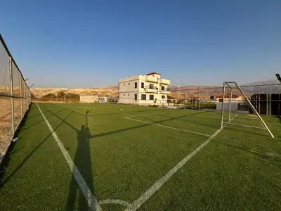 an empty soccer field with a goal on it at Rest Sea Chalet shearing Room one bed
