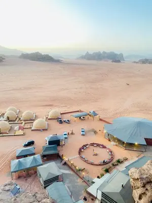 an aerial view of a desert with domes and tents at سفينة الصحراء وادي رم in Disah