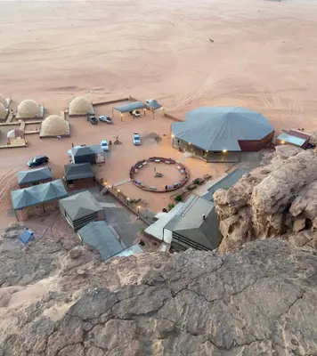 an aerial view of a camping area in the desert at سفينة الصحراء وادي رم in Disah