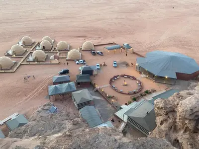an aerial view of domes in the desert at سفينة الصحراء وادي رم in Disah