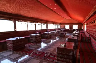a large room with tables and chairs in it at Wadi Rum Bubble Dream in Wadi Rum