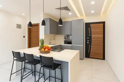 a kitchen with a island with bar stools at Central Amman Twin Towers Apartment 2 in Amman