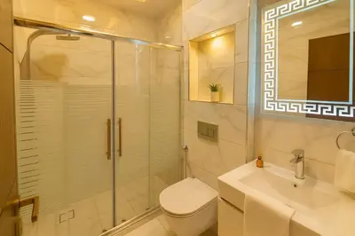 a bathroom with a shower and a toilet and a sink at Central Amman Twin Towers Apartment 2 in Amman